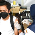 Seorang warga sedang menerima suntikan vaksin